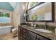 Bright bathroom boasts dual sinks, granite counters, decorative stone, and a modern tub at 266 Hogans Valley Way, Cary, NC 27513