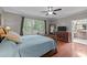 Comfortable bedroom featuring hardwood floors, a dresser, TV and lots of natural light at 266 Hogans Valley Way, Cary, NC 27513