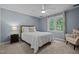 Comfortable bedroom features a ceiling fan, neutral carpet and a large window with peaceful view at 266 Hogans Valley Way, Cary, NC 27513