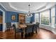 Elegant dining room with hardwood floors, blue walls, and large windows for abundant natural light at 266 Hogans Valley Way, Cary, NC 27513