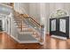Elegant entryway featuring hardwood floors, staircase with decorative iron railings, and decorative front door at 266 Hogans Valley Way, Cary, NC 27513