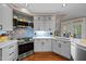 Stylish kitchen with stainless steel appliances, white countertops, and tiled backsplash at 266 Hogans Valley Way, Cary, NC 27513