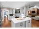 Modern kitchen with an island, stainless steel appliances, and stylish backsplash at 266 Hogans Valley Way, Cary, NC 27513
