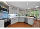 Well-lit kitchen with updated appliances, stylish backsplash, and quartz countertops at 266 Hogans Valley Way, Cary, NC 27513