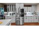 Modern kitchen with stainless steel refrigerator and stylish grey cabinetry at 266 Hogans Valley Way, Cary, NC 27513