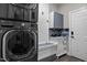 Efficient laundry room with modern washer/dryer, built-in storage, and stylish sink and cabinet at 266 Hogans Valley Way, Cary, NC 27513