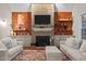Inviting living room featuring a fireplace, wood paneling, and neutral color scheme at 266 Hogans Valley Way, Cary, NC 27513