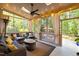 Inviting screened porch featuring cozy seating, ceiling fan and string lights for relaxed outdoor living at 266 Hogans Valley Way, Cary, NC 27513