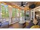 Relaxing screened-in porch features an outdoor TV, comfortable seating and stylish decor at 266 Hogans Valley Way, Cary, NC 27513