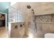 Elegant tiled shower featuring glass block and stone tile, with a modern shower head at 266 Hogans Valley Way, Cary, NC 27513