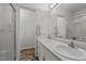 Bathroom featuring a double sink vanity with marble countertop and a walk-in shower at 2719 S Nc 87, Graham, NC 27253
