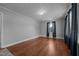 Bedroom featuring hardwood floors, light gray walls, and a window with stylish dark curtains at 2719 S Nc 87, Graham, NC 27253