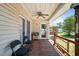 Covered deck with ceiling fan and outdoor seating, perfect for relaxation at 2719 S Nc 87, Graham, NC 27253
