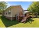 Large wooden deck features an umbrella, grill and stairs to a spacious yard at 2719 S Nc 87, Graham, NC 27253