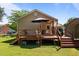 Wooden deck with umbrella, grill and stairs leading to large, grassy yard at 2719 S Nc 87, Graham, NC 27253