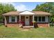 Charming brick home with covered front porch and lovely flower baskets, plus a well-manicured lawn at 2719 S Nc 87, Graham, NC 27253