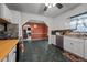Traditional kitchen featuring white cabinetry, a window, and a view into the living room at 2719 S Nc 87, Graham, NC 27253