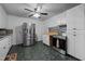 Traditional kitchen with stainless steel appliances, black and white tiled floors, and stone backsplash at 2719 S Nc 87, Graham, NC 27253