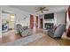Cozy living room with fireplace, hardwood flooring and access to the laundry room at 2719 S Nc 87, Graham, NC 27253
