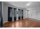 Bright living room with hardwood floors, neutral gray walls, large windows and stylish dark curtains at 2719 S Nc 87, Graham, NC 27253