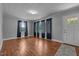 Bright living room with hardwood floors, neutral gray walls, large windows and stylish dark curtains at 2719 S Nc 87, Graham, NC 27253