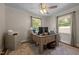Office area with a wooden desk, a ceiling fan, carpet flooring and two windows at 2719 S Nc 87, Graham, NC 27253