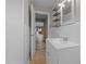 Clean bathroom with tiled floors, a vanity and open shelving at 305 W Old Rd, Lillington, NC 27546