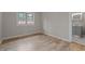 This bedroom features wood floors, a neutral color scheme, and a window for natural light at 305 W Old Rd, Lillington, NC 27546