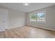 Cozy bedroom with wood look floors, natural light and neutral paint at 305 W Old Rd, Lillington, NC 27546