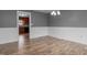 Charming dining room with wainscotting, neutral paint, and wood look flooring at 305 W Old Rd, Lillington, NC 27546