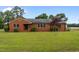 Charming single-story brick home with a well-manicured lawn and mature landscaping at 305 W Old Rd, Lillington, NC 27546