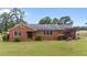 Charming single-story brick home with a well-manicured lawn and mature landscaping at 305 W Old Rd, Lillington, NC 27546