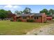 Spacious property featuring a well-maintained brick home with a lush green lawn at 305 W Old Rd, Lillington, NC 27546