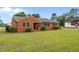 A charming brick ranch style home with well-manicured landscaping and a beautiful green lawn at 305 W Old Rd, Lillington, NC 27546