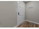 Hallway with wood look flooring and a white painted door at 305 W Old Rd, Lillington, NC 27546