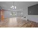 Large living room with wood-look floors, fireplace, neutral paint, and good natural light at 305 W Old Rd, Lillington, NC 27546