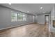 Open concept living area with large window, wood-look floors, and great natural light at 305 W Old Rd, Lillington, NC 27546