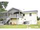 The backyard features a covered deck, stairs, and exterior access to a painted brick home at 3141 Wagoner Ln # 09, Graham, NC 27253
