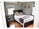Quaint bedroom with a comfortable bed, a nearby keyboard, and two windows at 3141 Wagoner Ln # 09, Graham, NC 27253