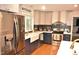Modern kitchen featuring stainless steel appliances, a farmhouse sink, and a custom backsplash design at 3141 Wagoner Ln # 09, Graham, NC 27253