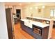 Updated kitchen with stainless steel appliances, an island with bar seating, and hardwood floors at 3141 Wagoner Ln # 09, Graham, NC 27253