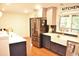 Bright and modern kitchen featuring an island, stainless steel appliances, and a farmhouse sink at 3141 Wagoner Ln # 09, Graham, NC 27253