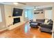 Inviting living room featuring hardwood floors, a cozy fireplace, and modern ceiling fan at 3141 Wagoner Ln # 09, Graham, NC 27253