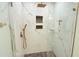Close up of an Elegant marble shower with bronze fixtures and dual built-in shower niches at 3141 Wagoner Ln # 09, Graham, NC 27253