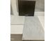Interior design choices featuring dark wood cabinet, white countertop, and light gray tiling at 331 Chesapeake Cmns St # 106, Garner, NC 27529