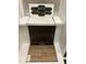 Interior design choices featuring dark green hexagon tiles, white countertop, and wood look flooring at 331 Chesapeake Cmns St # 106, Garner, NC 27529