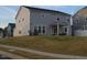 Home's exterior boasts a covered patio, a well-maintained yard, and a serene neighborhood setting at 3313 Brunot St, New Hill, NC 27562