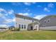 Attractive home exterior with a covered patio, offering a serene and private backyard space at 3313 Brunot St, New Hill, NC 27562