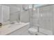 Bright bathroom featuring a vanity sink, tile shower, and toilet with glass door at 3313 Brunot St, New Hill, NC 27562