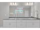 Bright bathroom featuring a double sink vanity, a large mirror, and white cabinets for ample storage at 3313 Brunot St, New Hill, NC 27562